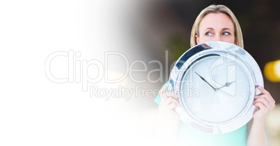 Woman holding clock in front of room