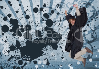 Excited young student man jumping and holding a diploma against blue splattered background