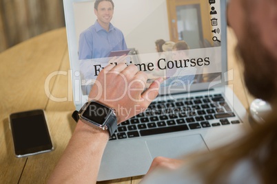 Man using a computer with e-learning information in the screen