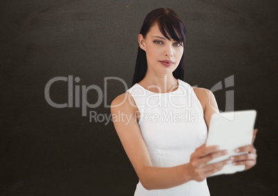 Woman with tablet in front of blackboard