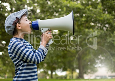 Boy with megaphone in front of trees