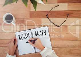 Begin again  text written on page with coffee and glasses
