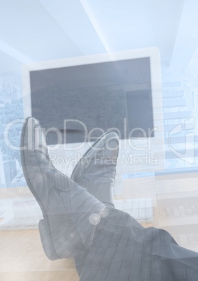 Legs relaxing on desk in office