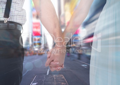 Couples hands holding together in city rush