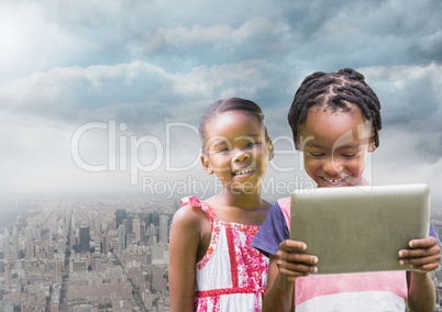 kids on a tablet with city background