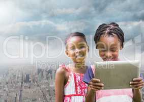 kids on a tablet with city background