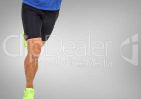 Athletic man running in front of grey background