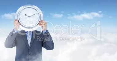 man holding clock in front of sky