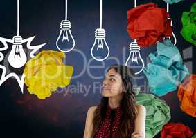 Woman standing next to light bulbs with crumpled paper balls