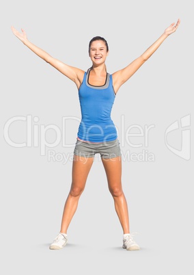 Full body portrait of athletic fit woman standing with grey background