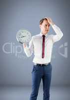 Woman holding clock in front of grey room