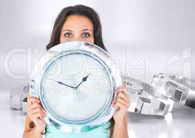 Woman holding chrome clock in front of chrome silver cog wheels
