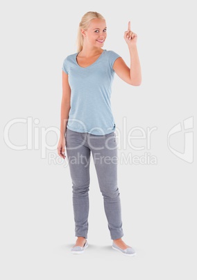 Full body portrait of woman pointing and standing with grey background