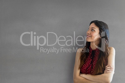 Happy business woman looking up against grey background