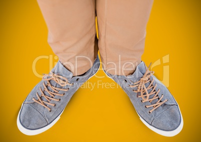 Feet and shoes  over yellow background
