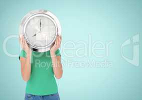 Woman holding clock in front of blue background