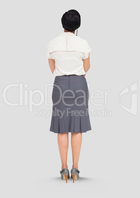 Full body portrait of woman standing with grey background