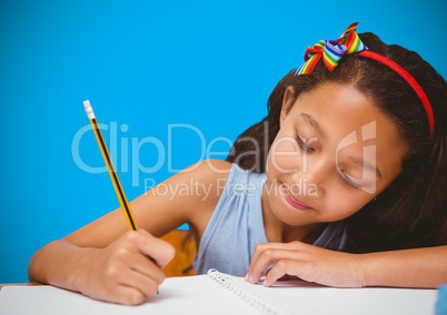 Girl writing in front of blue blank background