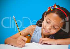 Girl writing in front of blue blank background