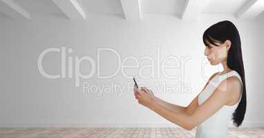 Business woman holding a phone against white wall background