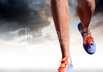 Athletic legs running in front of clouds