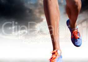 Athletic legs running in front of clouds