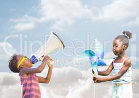 kids playing with megaphone and wind toy with cloudy background