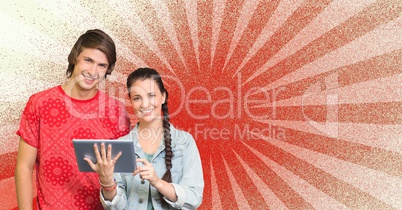 Happy young students holding a tablet against red and white background