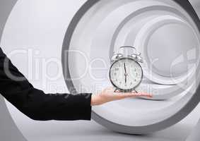 Arm holding clock in front of tunnel circles