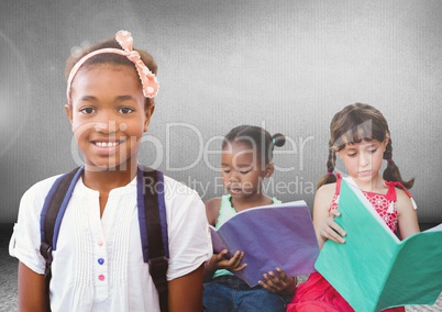 Kids reading books in front of grey room