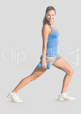 Full body portrait of athletic slim woman exercising with grey background