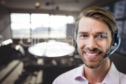 Happy customer care representative man against office background