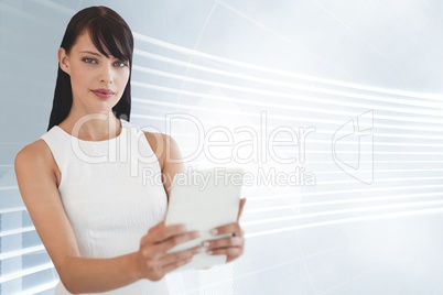 Business woman holding a tablet against white and blue background