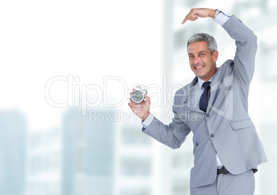 man holding clock in front of city