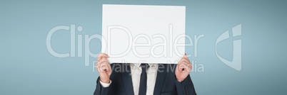 Business man holding a blank card against blue background