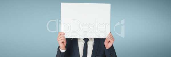 Business man holding a blank card against blue background