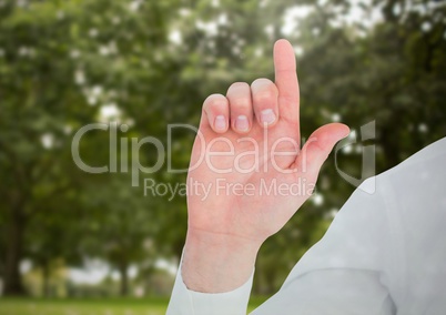 Hands pointing up in front of  trees