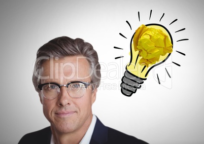 Man  next to light bulb with crumpled paper ball