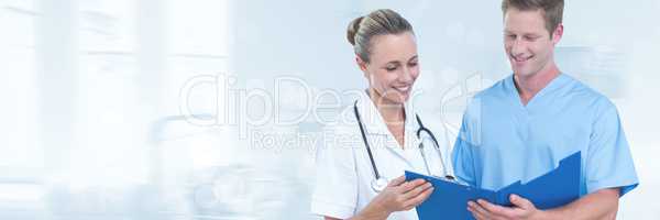 Doctors looking at documents against grey background