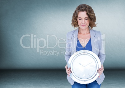 Woman holding clock in front of room