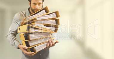 Business man holding folders against yellow blurred background