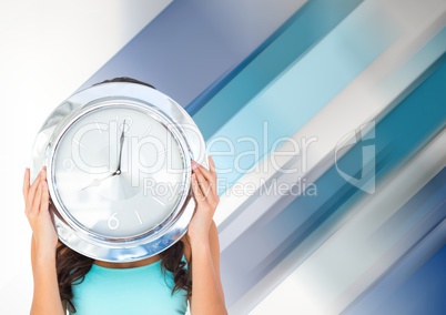 Woman holding clock in front of diagonal stripes effect