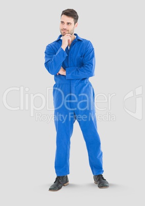 Full body portrait of mechanic Man standing with grey background