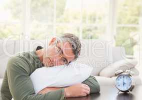 man tired by clock in front of windows