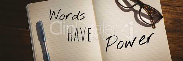 Words have power  text written on page with wood