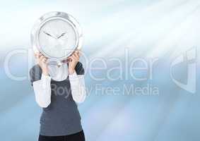 Woman holding clock in front of light streaks