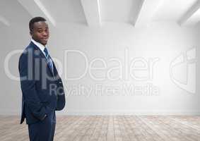 Business man standing against white wall background