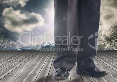 Businessman's legs in front of dramatic sky