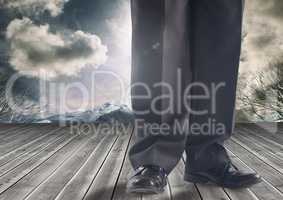 Businessman's legs in front of dramatic sky