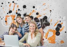 Happy young students using a computer against grey, yellow and black splattered background